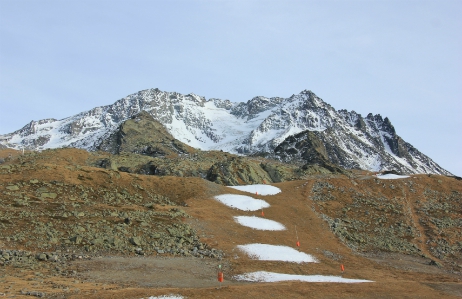 Patches of snow on a ski piste