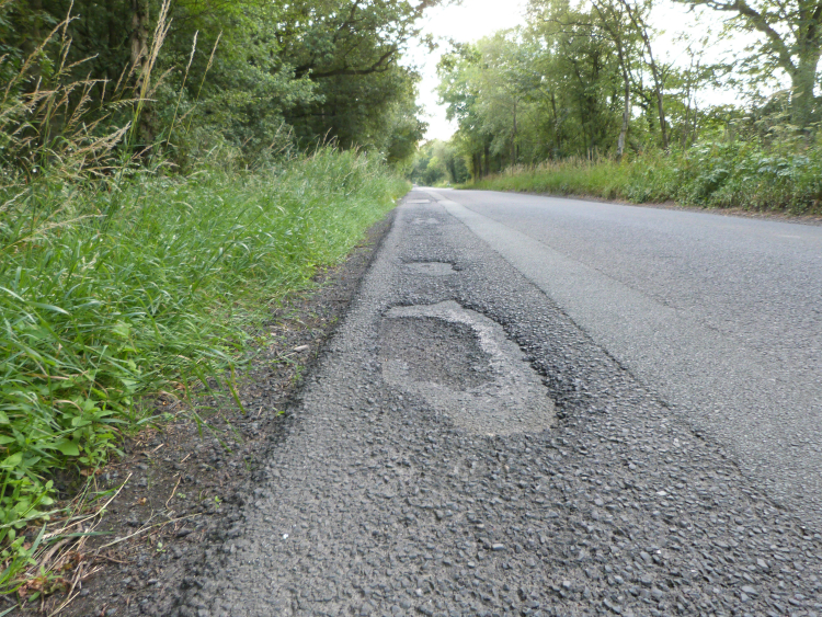 Poor road surface on Penny Pot Lane, Harrogate