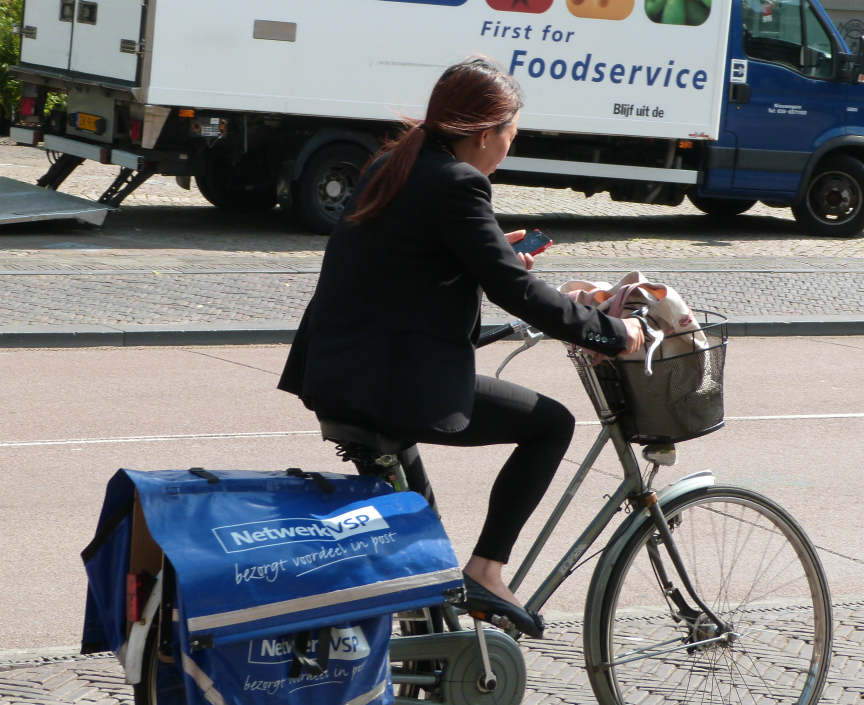 Cyclist using mobile phone in Utrecht