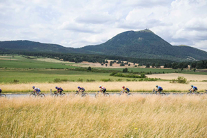 Riders pass the Puy de Dome on Stage 10 TDF 2025